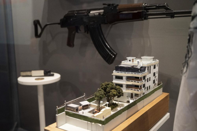 A model of the house where a precision counterterrorism operation killed al-Qaida's leader Ayman al-Zawahri is displayed below a rifle used by Michael Spann, the first American killed in Afghanistan, in the refurbished museum at the Central Intelligence Agency headquarters building in Langley, Virginia, on Saturday, Sept. 24, 2022. AP/RSS Photo